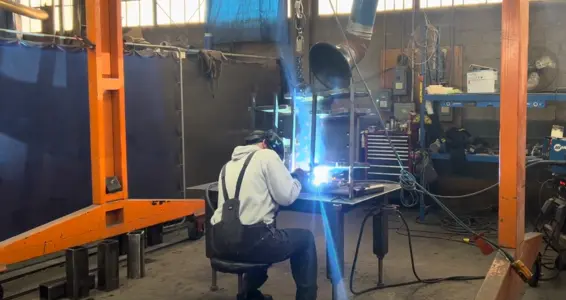 image of a lifco welder welding an excavator rake