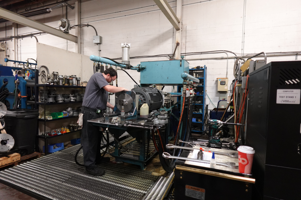 Russell, Hydraulic Mechanic, testing a pump on our gear bench.