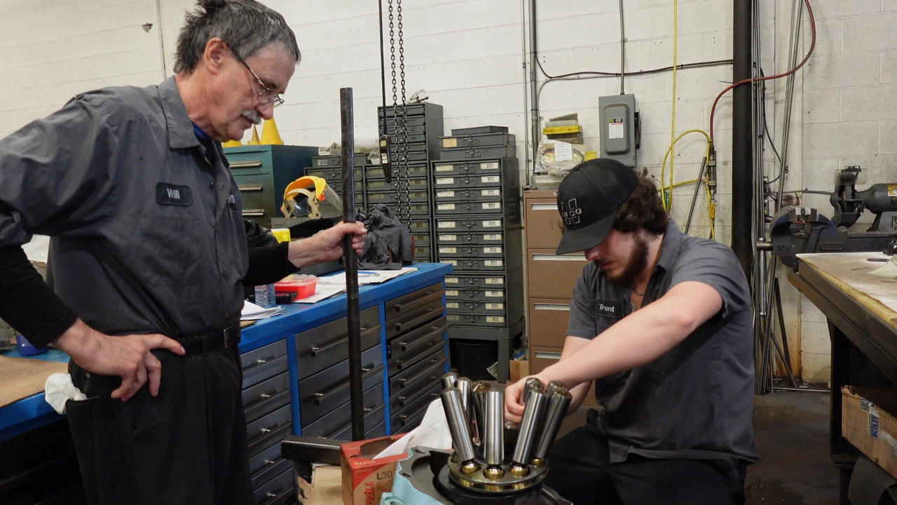 Trent and Willi, Jr and Sr Mechanic, respectively, working on a Parker M30